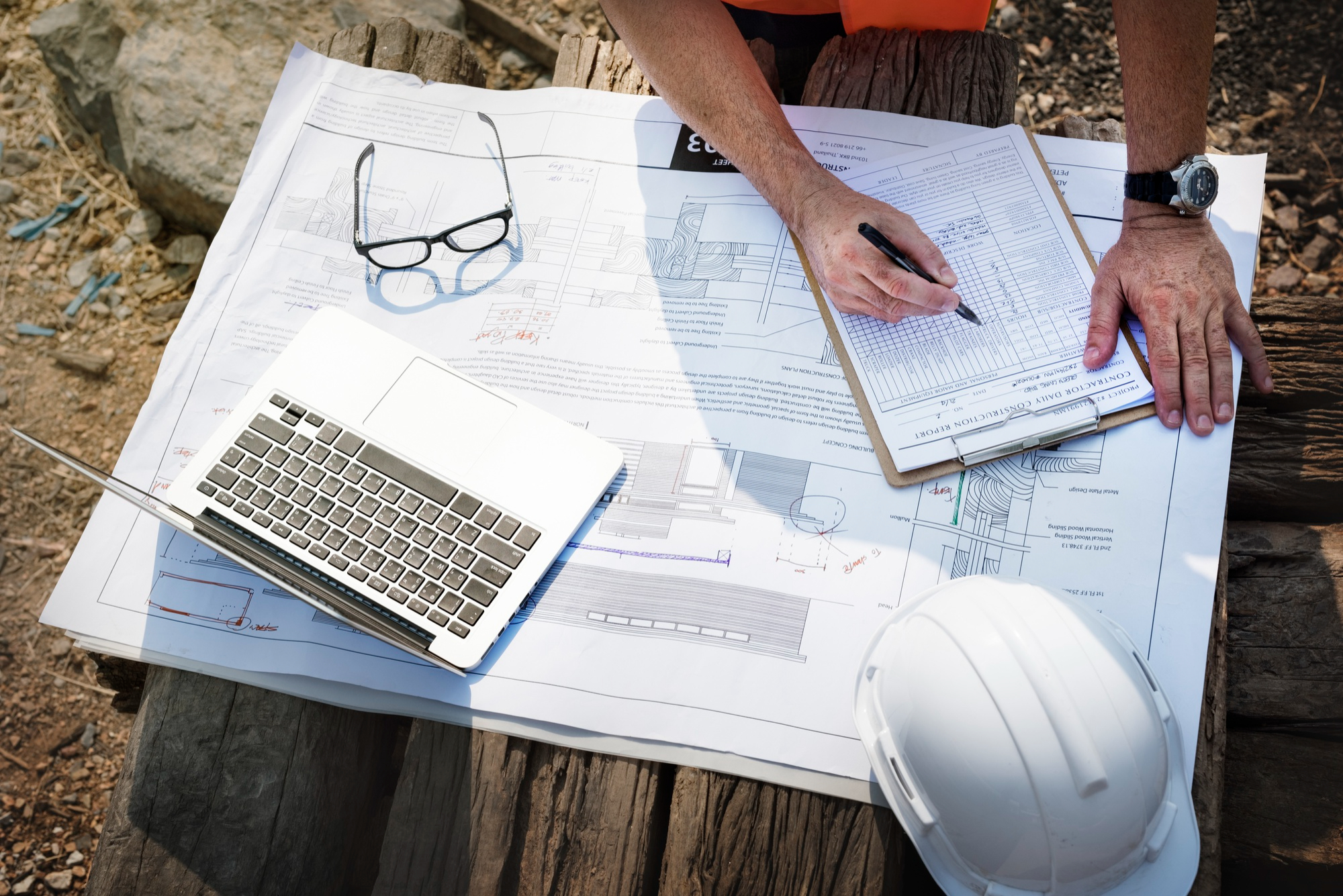 Technical project manager reviewing construction plans and quality documentation for mission critical infrastructure projects