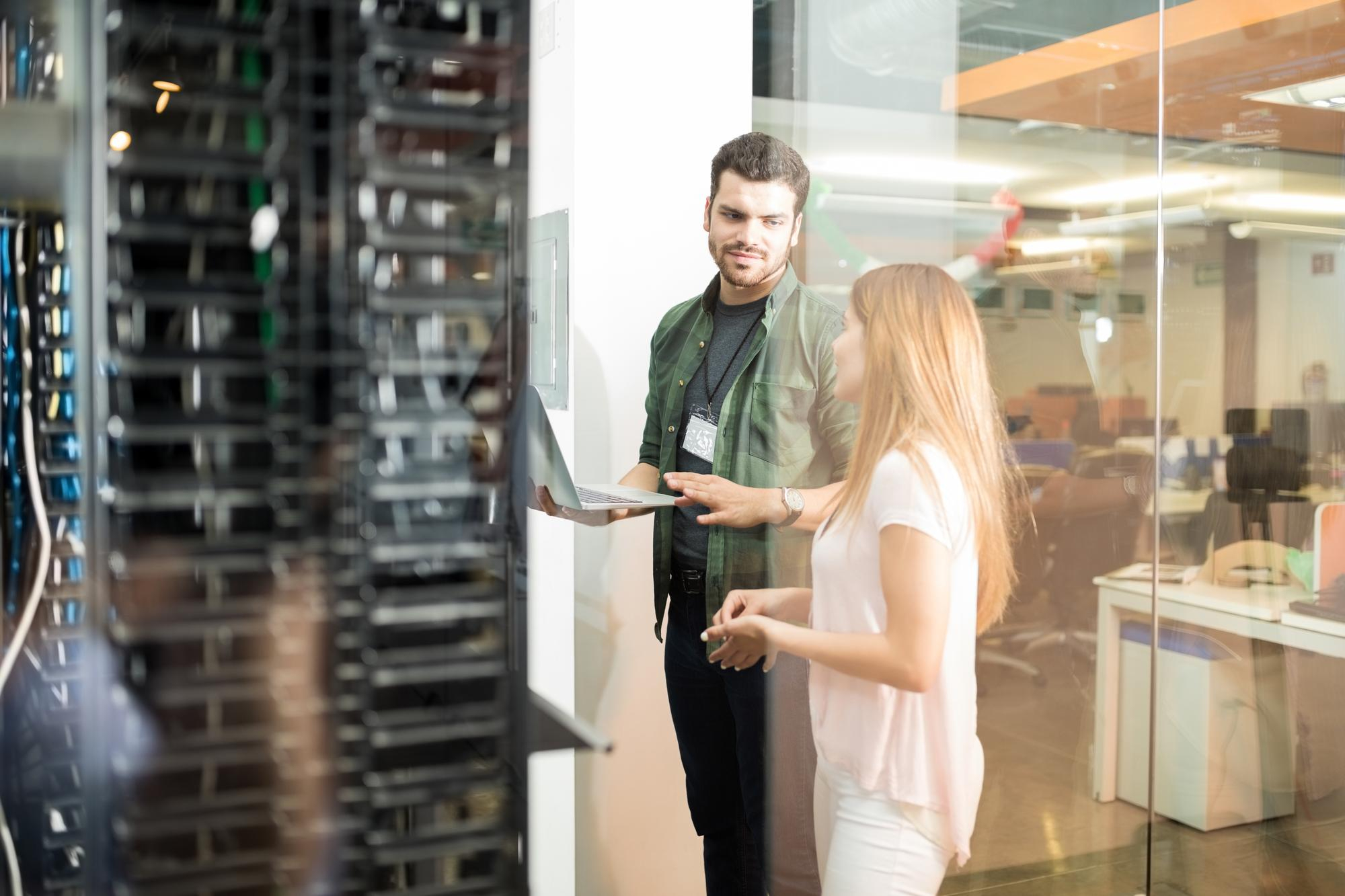 Technical project managers reviewing data centre infrastructure during commissioning and delivery